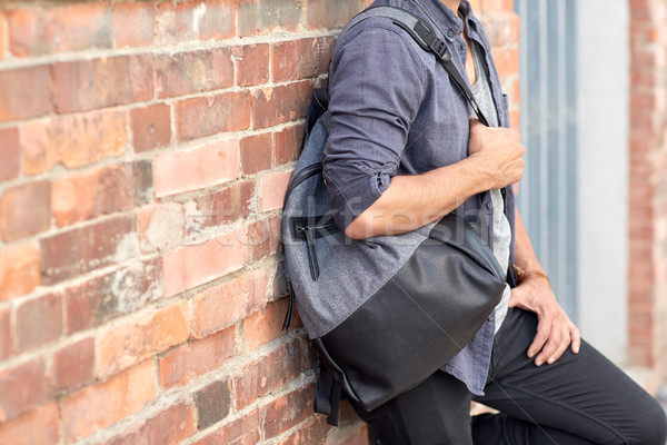 close up of man with backpack standing at wall Stock photo © dolgachov