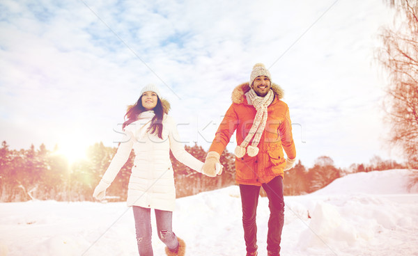 happy couple running in winter snow Stock photo © dolgachov