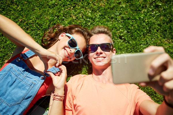 happy couple taking selfie on smartphone at summer Stock photo © dolgachov