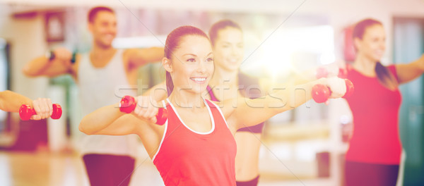 Stock photo: group of smiling people working out with dumbbells