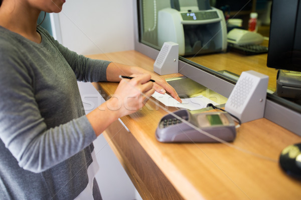 customer writing application at bank office Stock photo © dolgachov