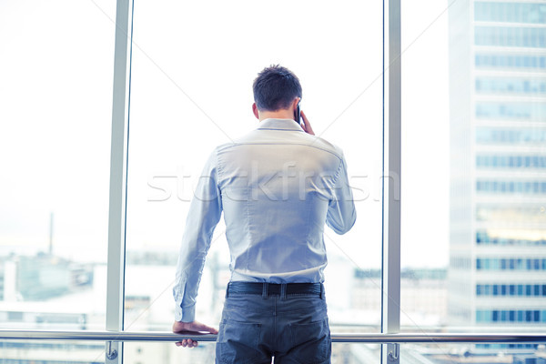 businessman calling on smartphone in office Stock photo © dolgachov