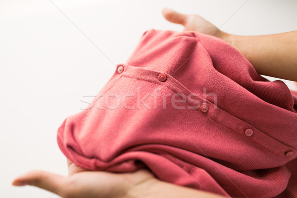 close up of hands with clothing item or cardigan Stock photo © dolgachov