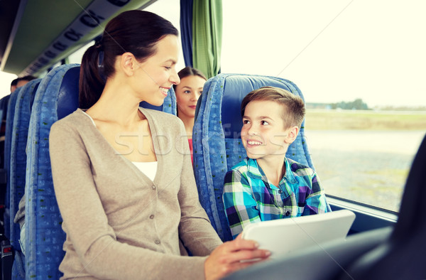 happy family with tablet pc sitting in travel bus Stock photo © dolgachov
