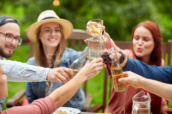 happy friends with drinks at summer garden party Stock photo © dolgachov