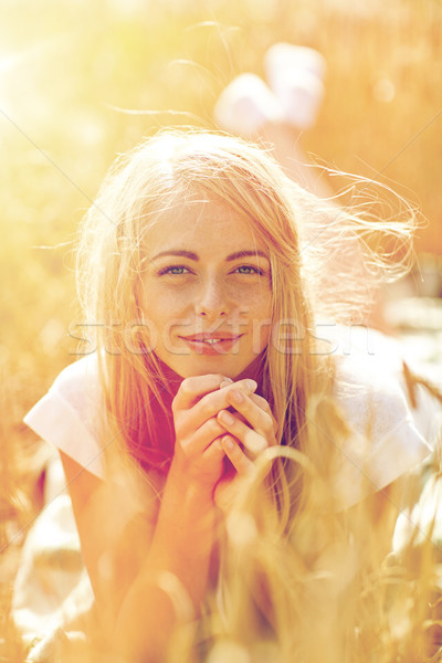 happy woman or teen girl lying in cereal field Stock photo © dolgachov