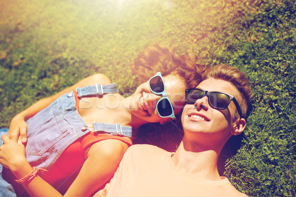 happy teenage couple lying on grass at summer Stock photo © dolgachov