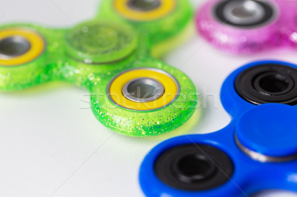 close up of fidget spinners on white background Stock photo © dolgachov