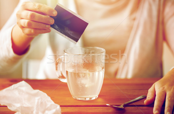 woman pouring medication into cup of water Stock photo © dolgachov
