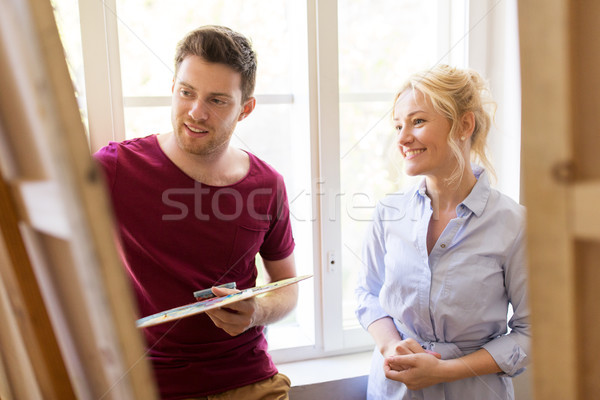 artists with palette and easel at art school Stock photo © dolgachov