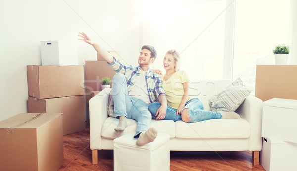 Stock photo: couple with boxes moving to new home and dreaming