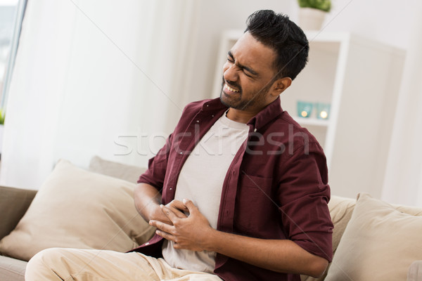 Unglücklich Mann Leiden Magenschmerzen home Menschen Stock foto © dolgachov