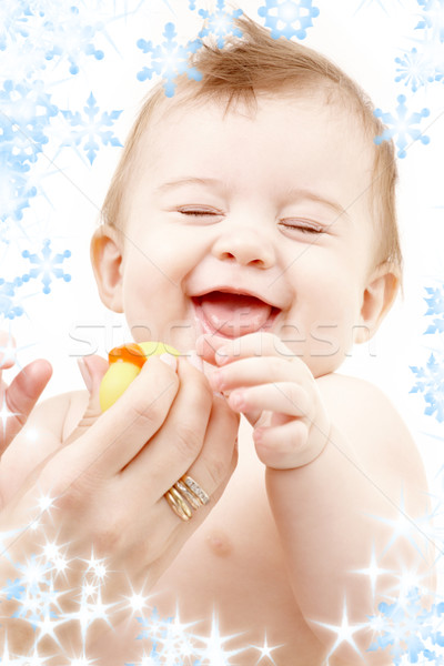 Stock photo: laughing baby boy in mother hands with rubber duck