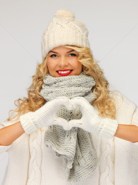beautiful woman in a winter clothes showing heart Stock photo © dolgachov