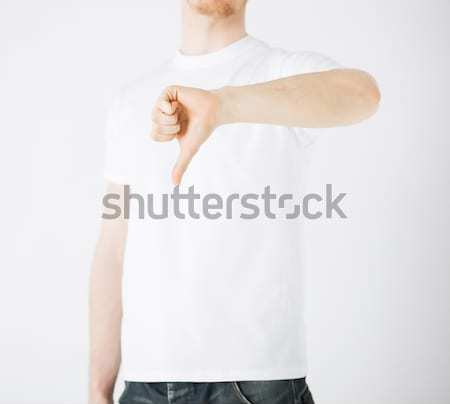 man showing thumbs down Stock photo © dolgachov