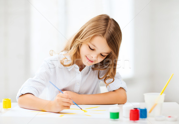 Stock photo: little girl painting at school