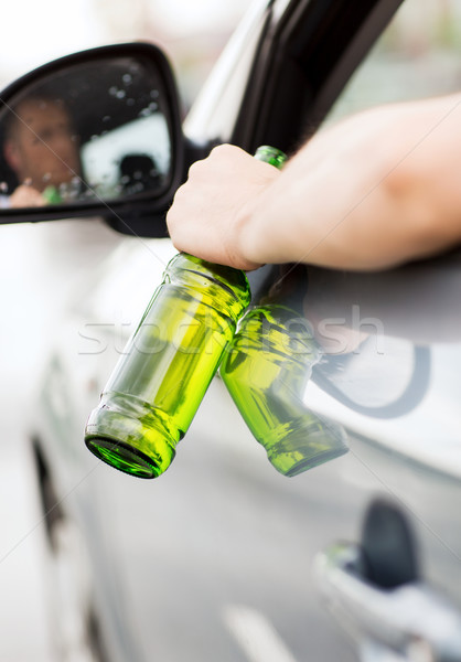 Stock photo: man drinking alcohol while driving the car