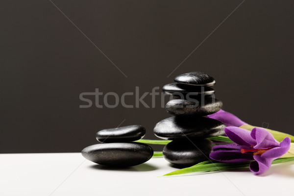 Stock photo: massage stones with flowers on mat