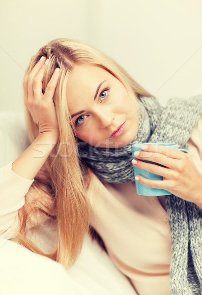 diseased woman with cup of tea Stock photo © dolgachov