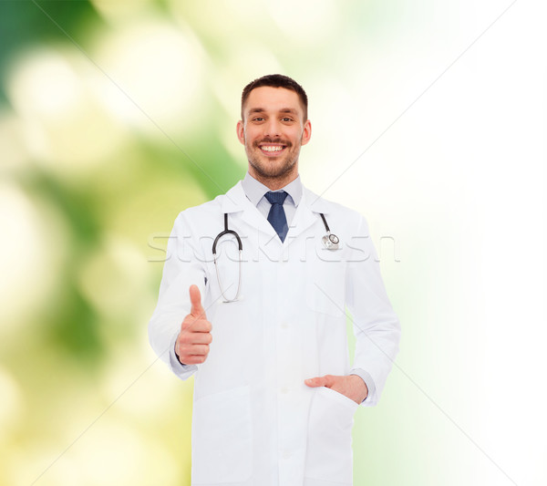 smiling doctor with stethoscope showing thumbs up Stock photo © dolgachov
