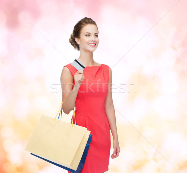 smiling woman with shopping bags and plastic card Stock photo © dolgachov