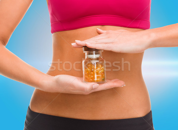 close up of female hands with bottle of capsules Stock photo © dolgachov