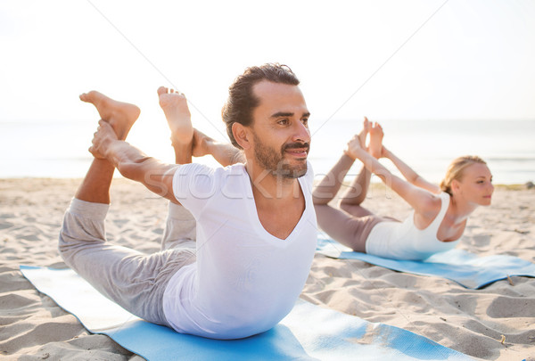 couple making yoga exercises outdoors Stock photo © dolgachov