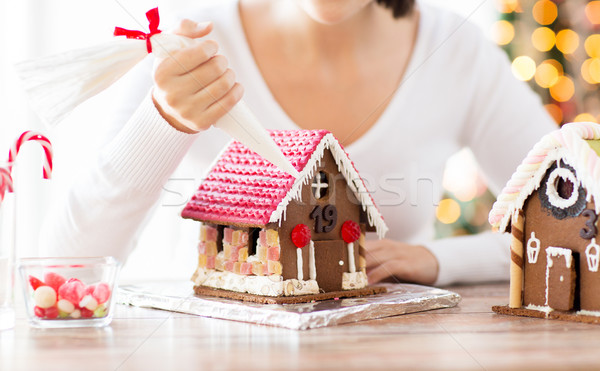Stock photo: close up of woman making gingerbread houses