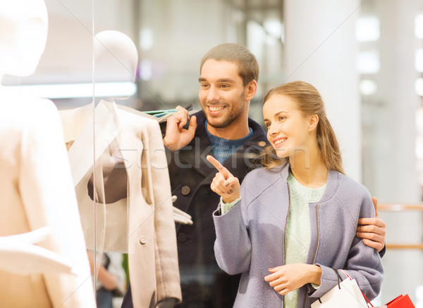 happy young couple with shopping bags in mall Stock photo © dolgachov