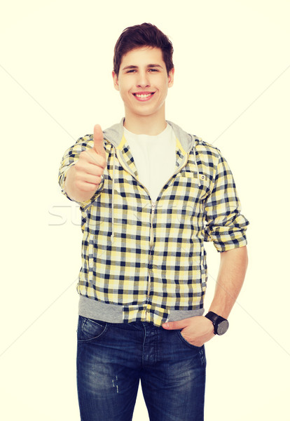 smiling student boy showing thumbs up Stock photo © dolgachov