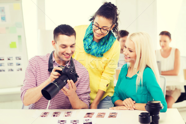 smiling team with photocamera working in office Stock photo © dolgachov