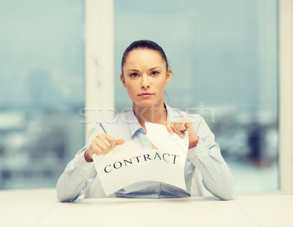 serious businesswoman tearing contract Stock photo © dolgachov