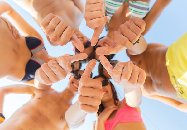 Stock photo: close up of friends showing thumbs in circle