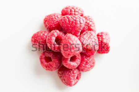eco food and objects concept - juicy fresh ripe red raspberris