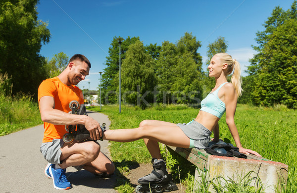 happy couple with rollerblades outdoors Stock photo © dolgachov