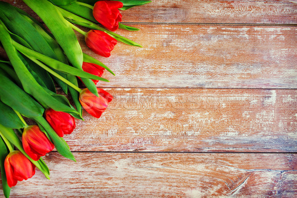 Stock photo: close up of red tulips on wooden background