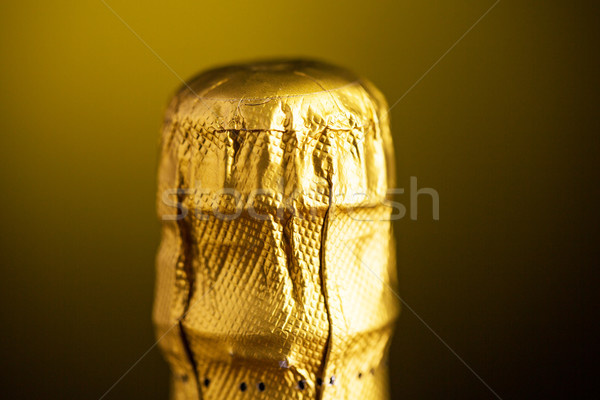 close up of champagne bottle cork wrapped in foil Stock photo © dolgachov