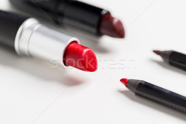 close up of two open lipsticks and lip pencils Stock photo © dolgachov