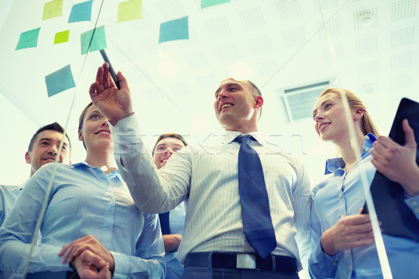 smiling business people with marker and stickers Stock photo © dolgachov