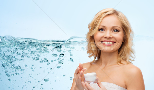 happy middle aged woman with moisturizing cream Stock photo © dolgachov