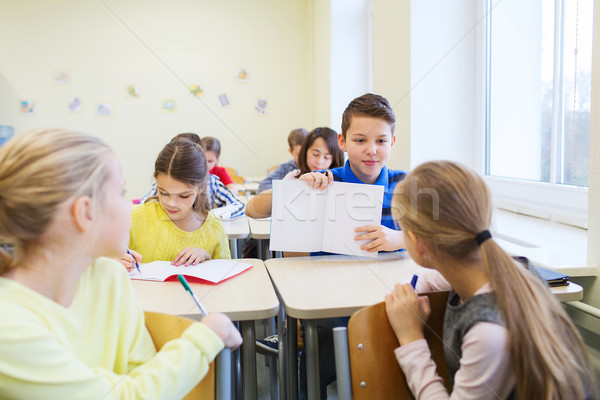group of school kids writing test in classroom Stock photo © dolgachov
