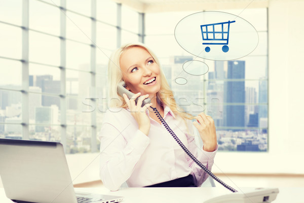 smiling businesswoman calling on telephone Stock photo © dolgachov