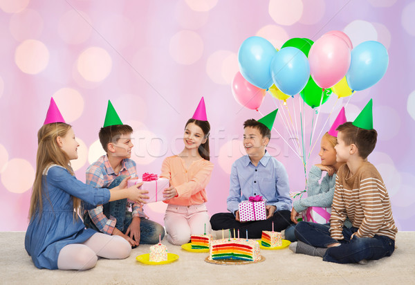 happy children giving presents at birthday party Stock photo © dolgachov