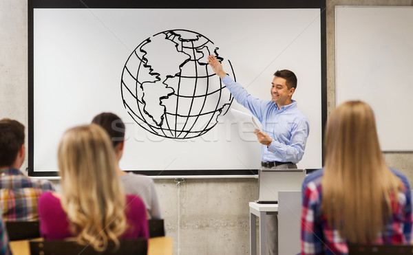 group of students and happy teacher at white board Stock photo © dolgachov