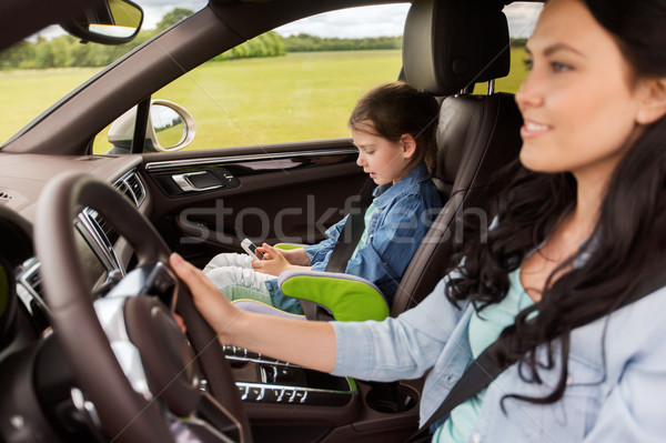 happy woman with little child driving in car Stock photo © dolgachov