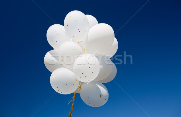 close up of white helium balloons in blue sky Stock photo © dolgachov