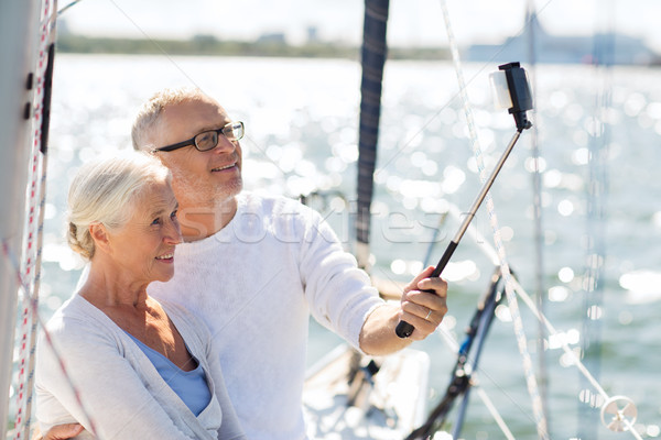 senior couple taking selfie on sail boat or yacht Stock photo © dolgachov