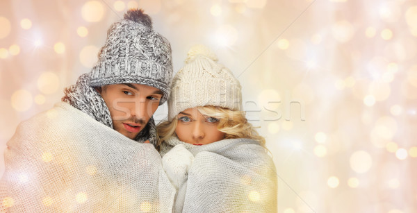 freezing couple in winter clothes wrapped to plaid Stock photo © dolgachov