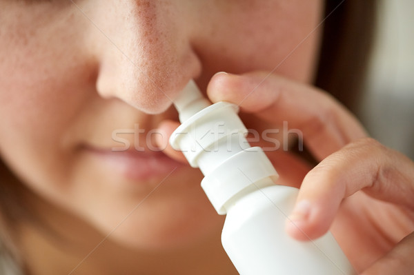 close up of sick woman using nasal spray Stock photo © dolgachov
