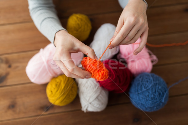 woman pulling yarn up into ball Stock photo © dolgachov